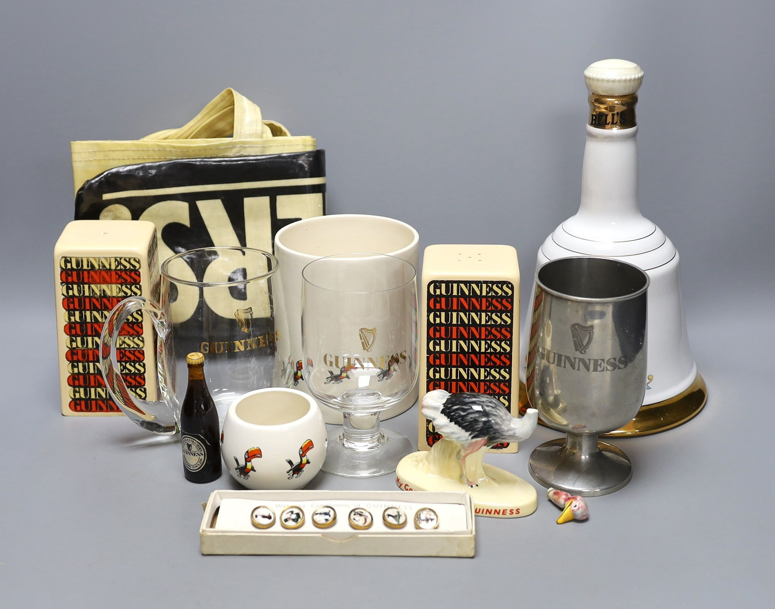 Assorted Guiness memorabilia, a Bells porcelain bottle of whisky, commemorative to the 60th birthday of Her Majesty Queen Elizabeth II